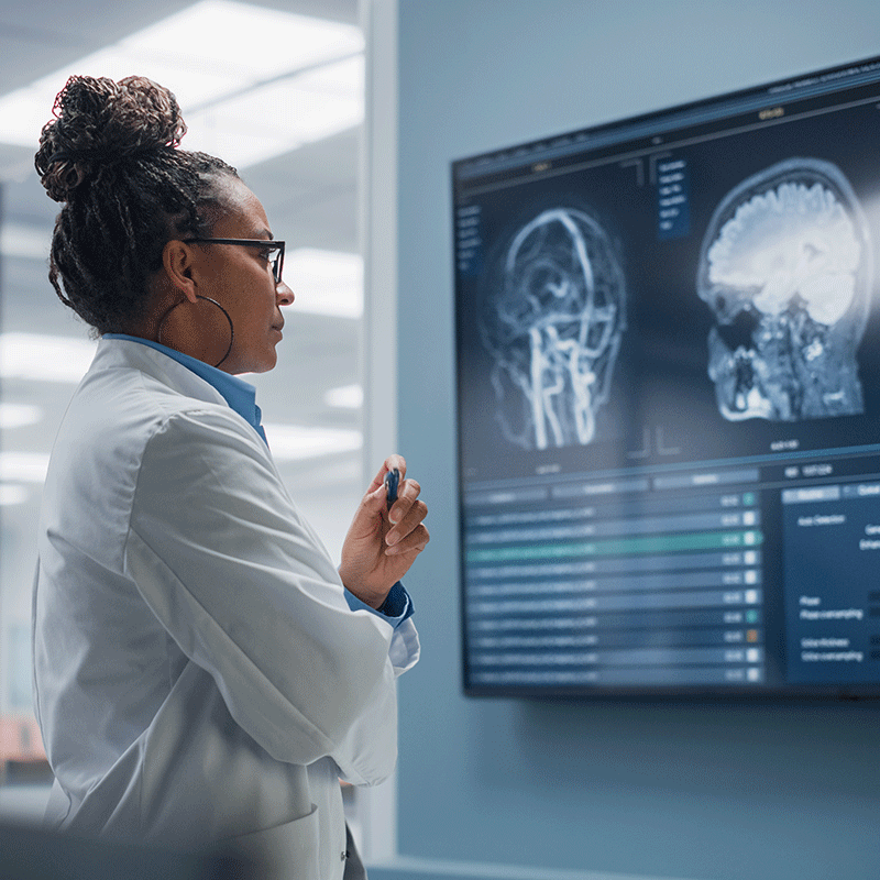 Female Researcher Looking at Brain Scans